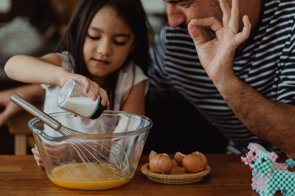 dad teaching daughter to cook